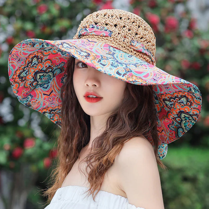 Young woman wearing a colorful wide-brim straw sun hat with paisley pattern outdoors