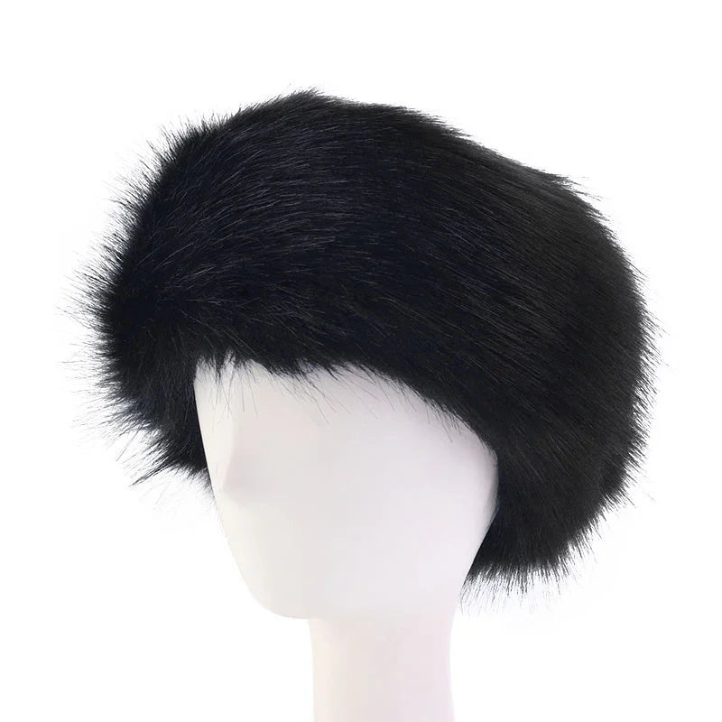 Black fur hat displayed on white mannequin head, stylish winter accessory