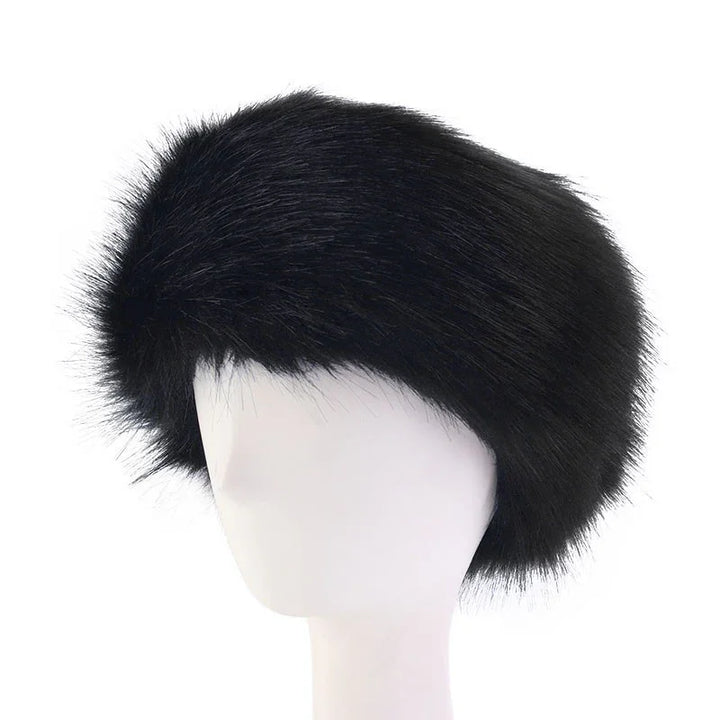 Black fur hat displayed on white mannequin head, stylish winter accessory