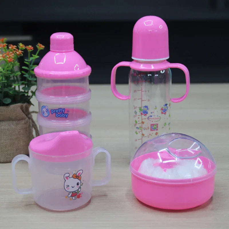 Set of pink baby feeding accessories including milk powder container, baby bottle, sippy cup, and cotton container on wooden table
