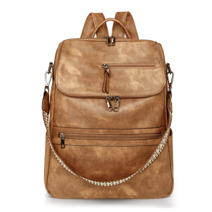 tan leather backpack with multiple zippered pockets and detachable woven shoulder strap