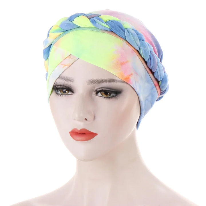 Woman mannequin wearing colorful tie-dye turban headwrap with braided detail