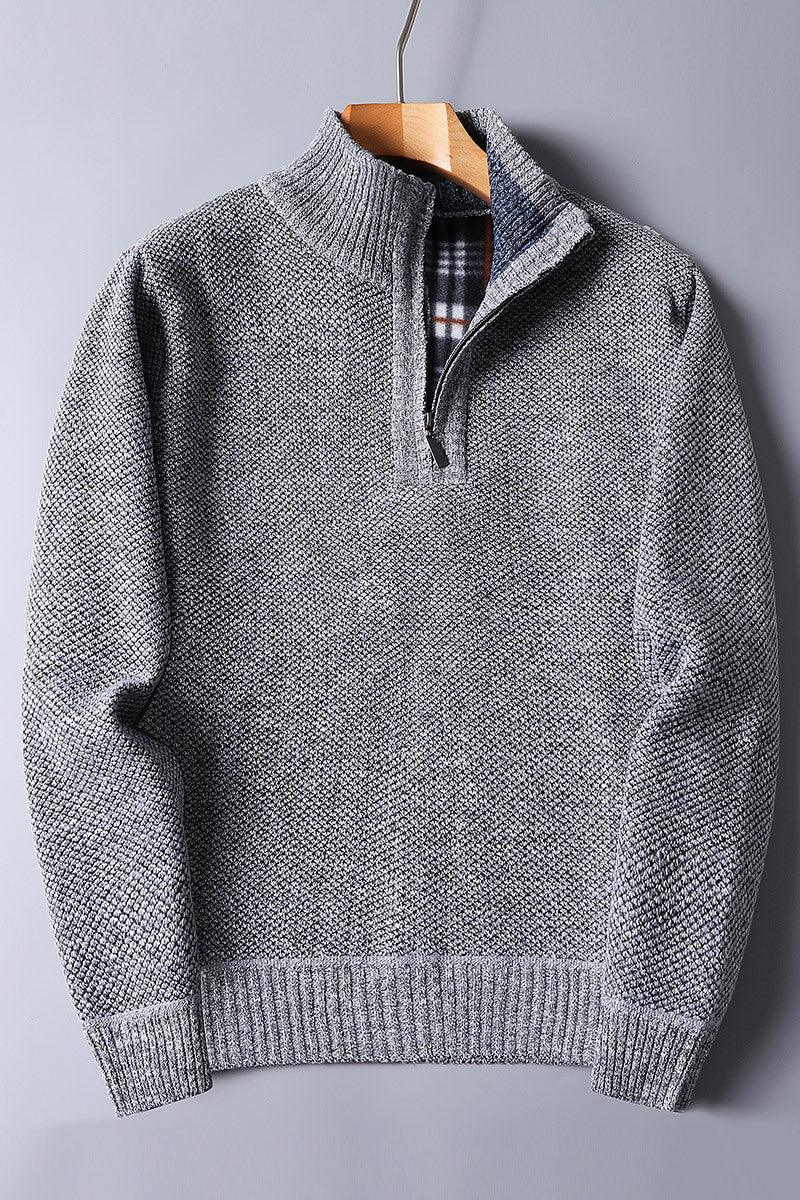 Grey textured knit sweater with quarter zipper and plaid inner collar on wooden hanger