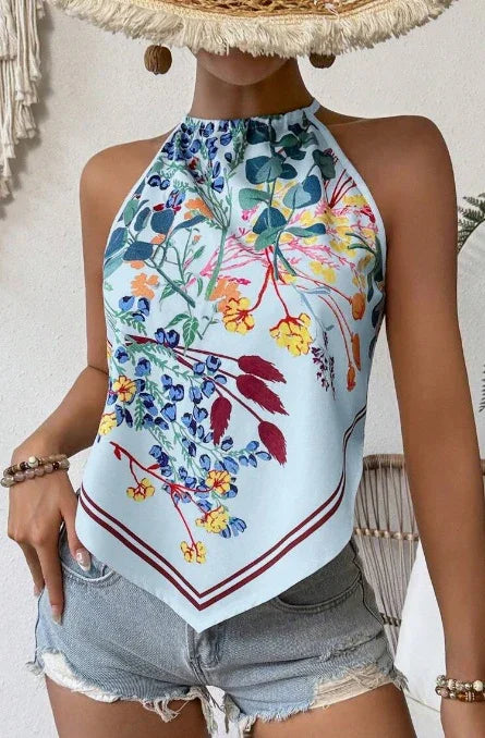 Woman wearing a floral halter neck scarf top paired with distressed denim shorts and boho accessories