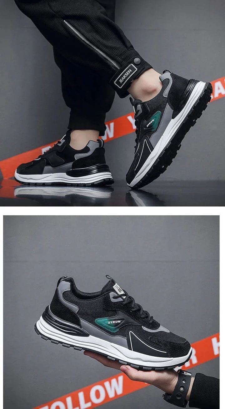 Black and gray XYRUN sneakers with white soles, worn with black JEAKSEN pants, urban background