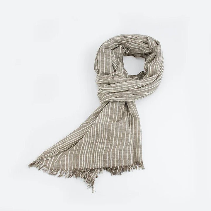 Beige lightweight striped scarf with fringed edges laid flat on a white background