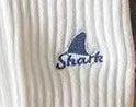 White ribbed fabric with blue embroidered shark fin and text logo design
