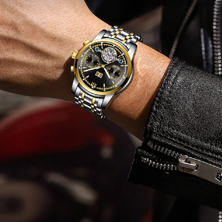 Luxury men's wristwatch with silver and gold metal band, black dial, and open-heart design