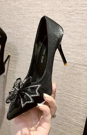Black high-heeled pointed toe shoe with sparkling rhinestone butterfly decoration