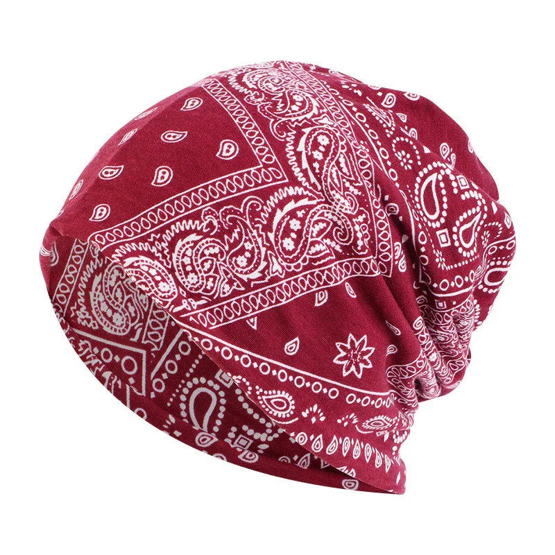 Red bandana print beanie hat with white paisley pattern and slouchy style