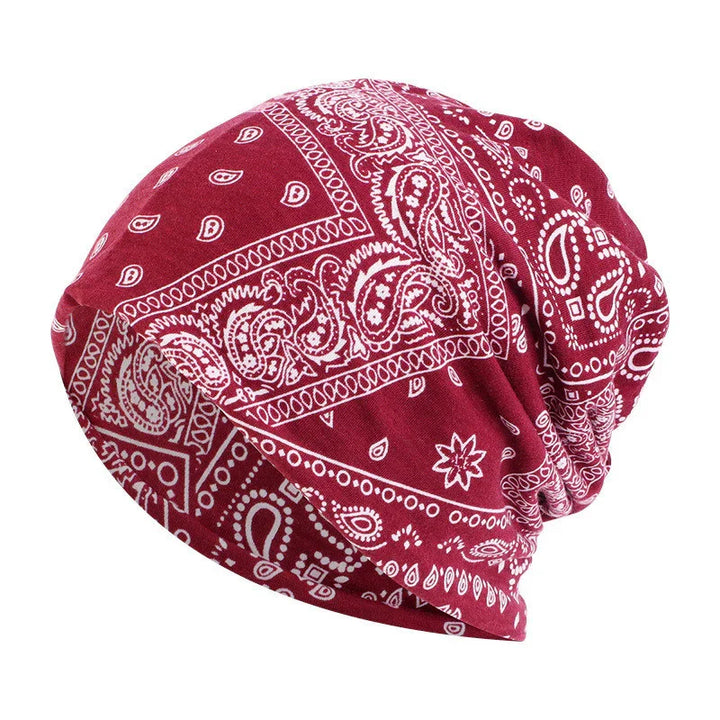 Red bandana print beanie hat with white paisley pattern and slouchy style