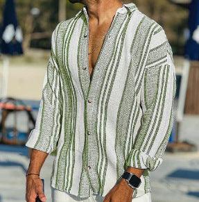 Man wearing a loose, striped green and white casual shirt with rolled-up sleeves at an outdoor setting