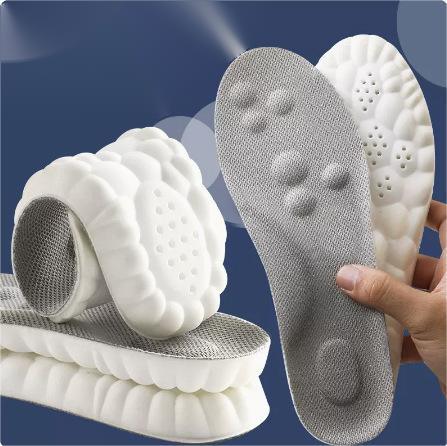 Cushioned white and gray honeycomb insoles displayed with blue background, hand holding one
