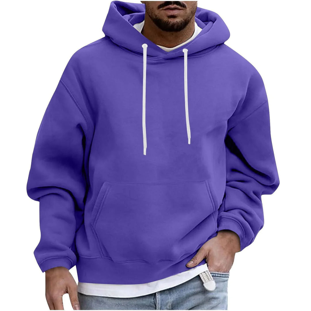 Man wearing a purple hoodie with white drawstrings and front pocket, paired with light blue jeans
