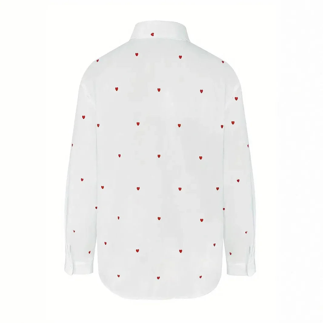 White long sleeve button-up shirt with small red heart patterns all over, shown from back
