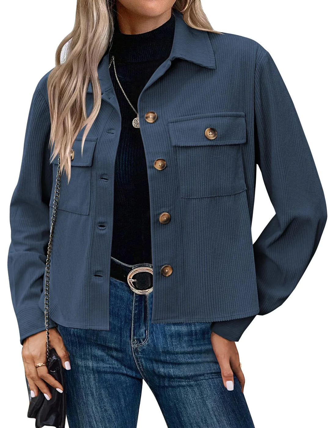 Woman wearing navy blue ribbed button-up jacket with chest pockets over black top and blue jeans