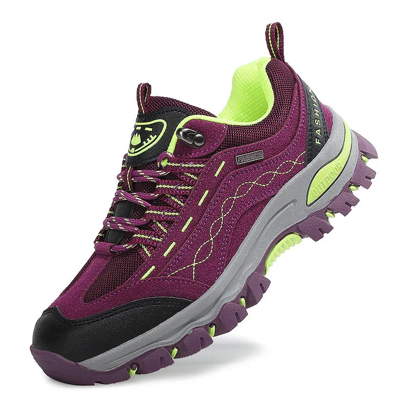 Women's purple and black trail running shoe with green accents and rugged sole
