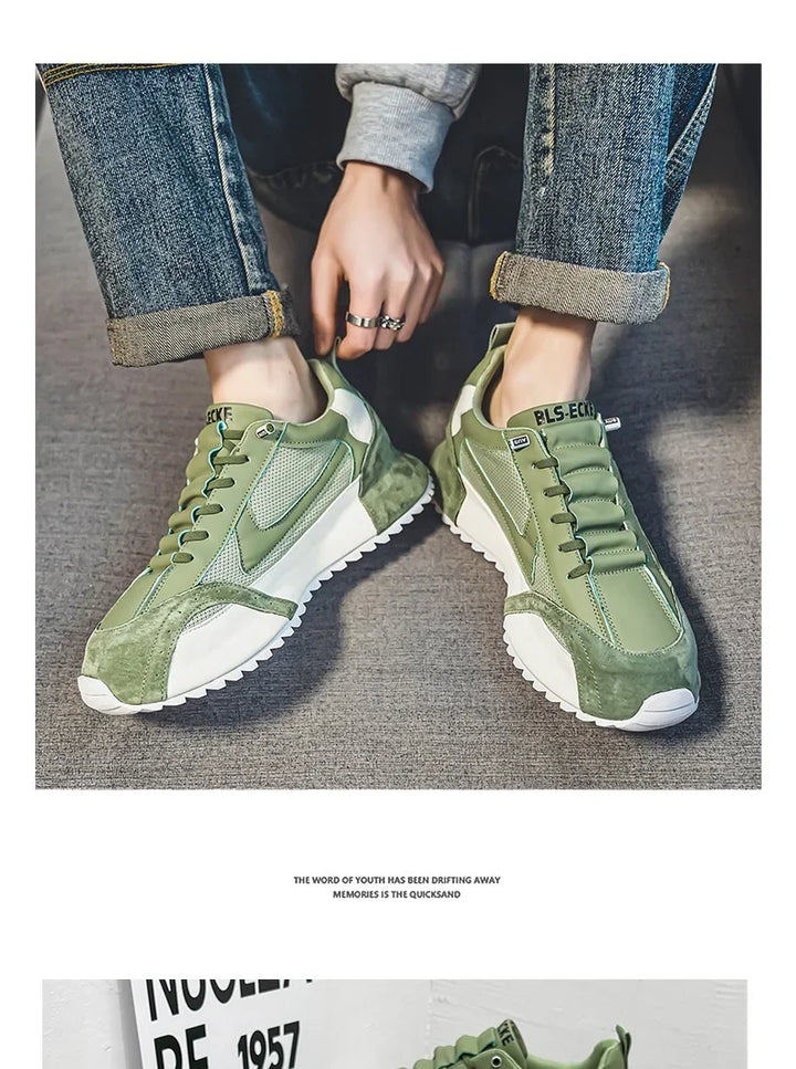 Person wearing green and white lace-up sneakers with denim jeans rolled at the cuffs on gray carpet