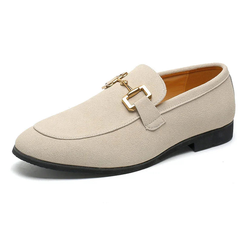 Beige suede men's loafer with gold metal buckle and black sole on white background