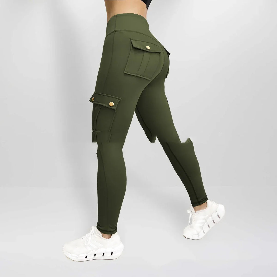 Woman wearing high-waisted olive green cargo leggings with flap pockets and white sneakers