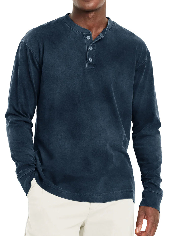 Men's navy blue long-sleeve henley shirt with three buttons, worn with beige pants