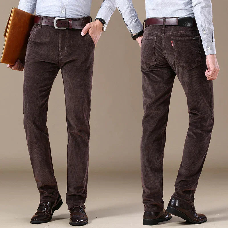 Men's brown corduroy pants with dark belt, worn with light gray shirt and black dress shoes