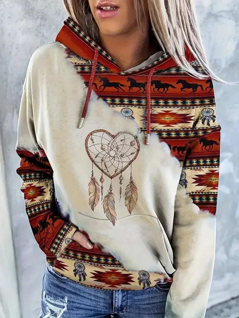 Woman wearing boho-style hoodie with dreamcatcher heart and horse patterns, paired with distressed jeans