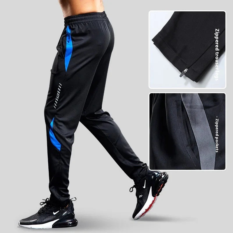 Men's black athletic track pants with blue accents and zippered trouser legs and pockets
