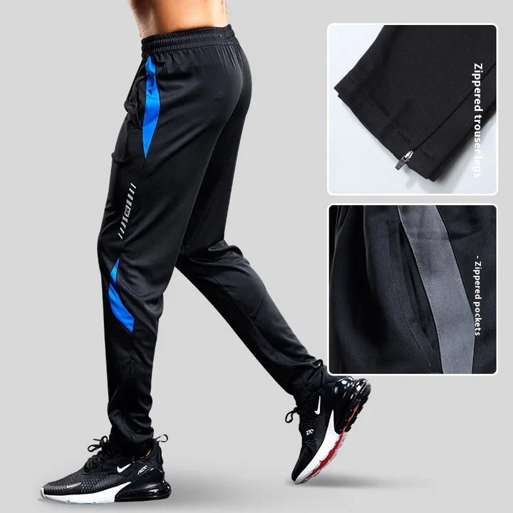 Men's black athletic track pants with blue accents and zippered trouser legs and pockets