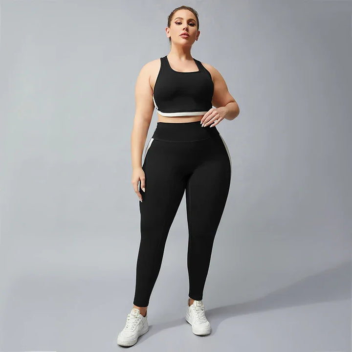 Plus size woman wearing black sports bra and leggings with white side stripes and white sneakers