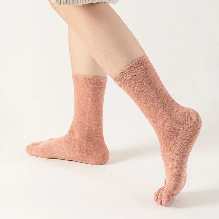 Legs wearing pink toe socks on white background, soft fabric ankle length socks