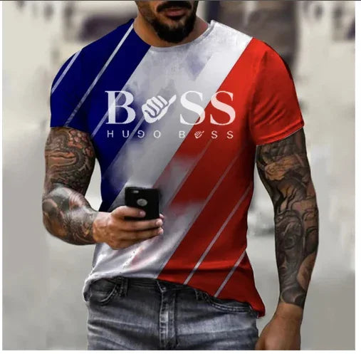Man wearing Hugo Boss tri-color red, white, blue graphic t-shirt with tattoos and holding a smartphone