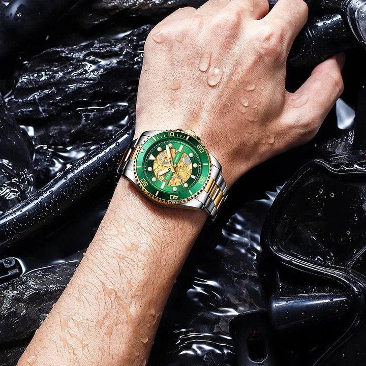 Water-resistant green and gold wristwatch on wet wrist holding scuba diving gear