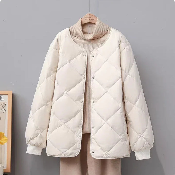 Off-white quilted button-up puffer jacket paired with beige turtleneck sweater and pants