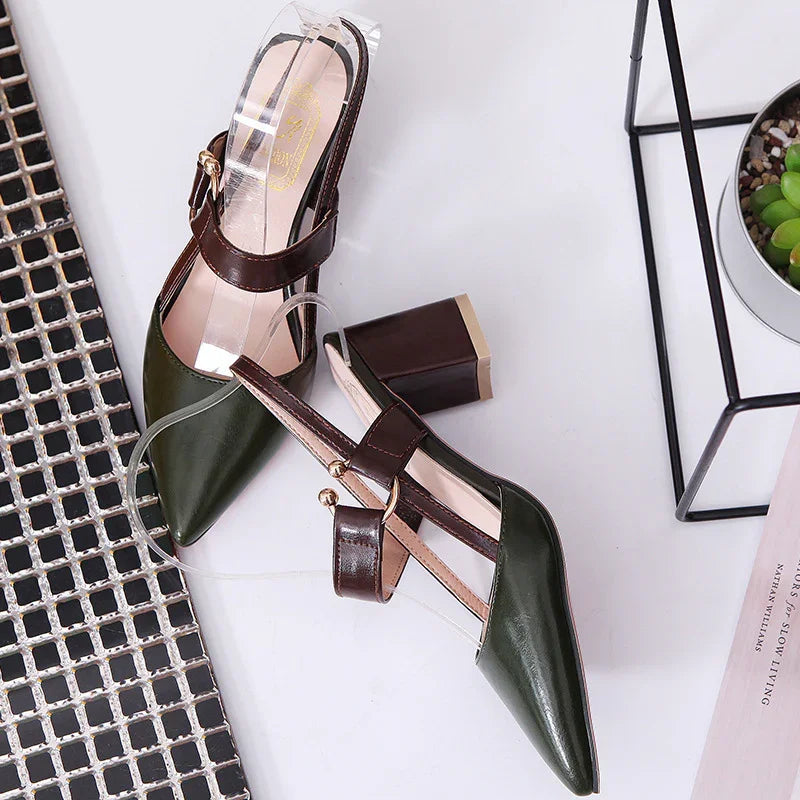 Pair of green and brown leather block heel slingback women's shoes on white surface