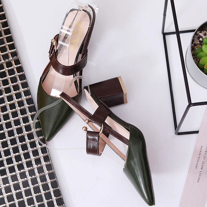 Pair of green and brown leather block heel slingback women's shoes on white surface