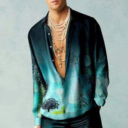 man wearing open black and turquoise gradient silk shirt with nature print and layered gold necklaces