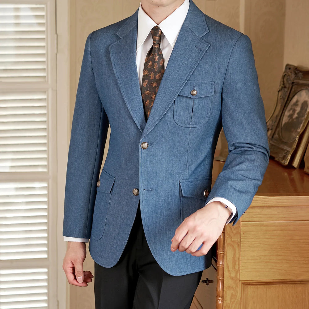 Man wearing blue tailored blazer with decorative buttons and floral tie indoors