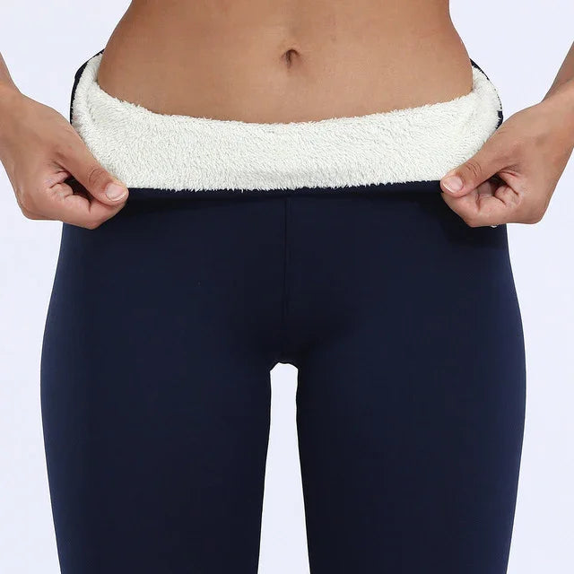 Close-up of woman wearing navy blue fleece-lined leggings, showing soft white inner lining at waist