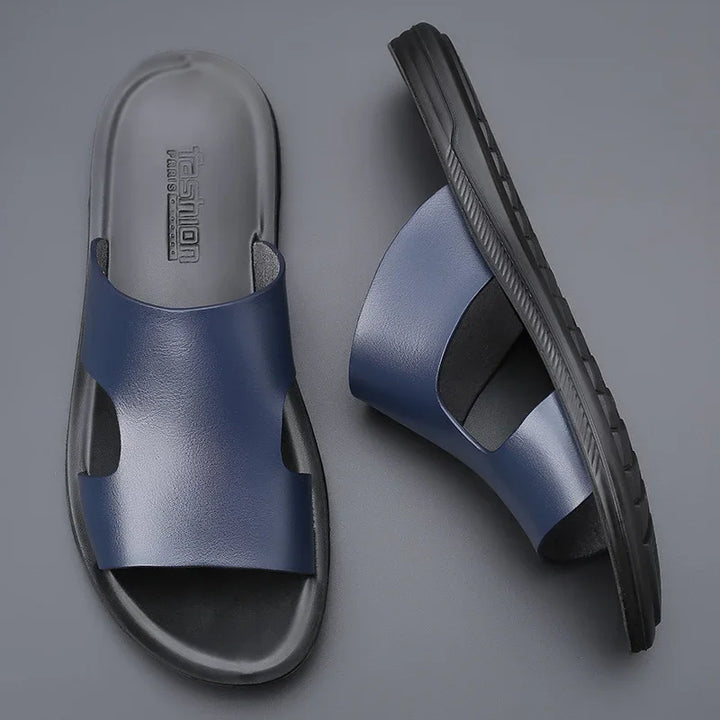 Blue and black casual men's slide sandals with cushioned sole on gray background