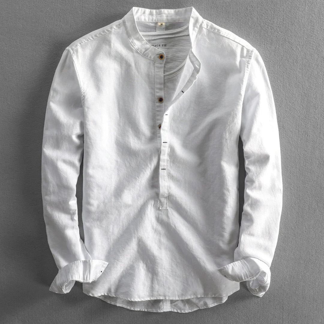 White long-sleeve men's shirt with mandarin collar and half button placket on gray background