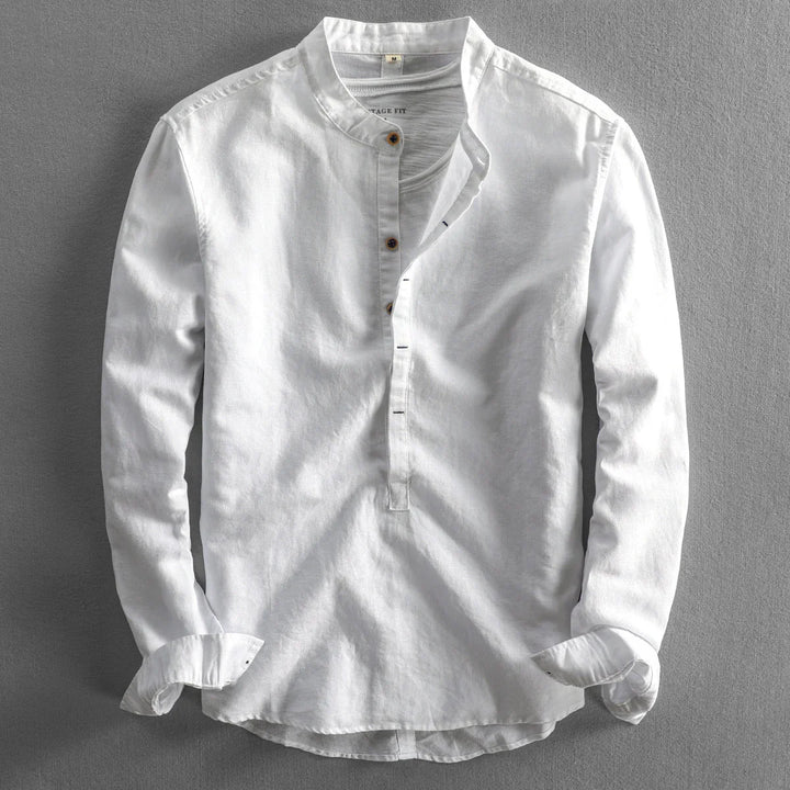 White long-sleeve men's shirt with mandarin collar and half button placket on gray background