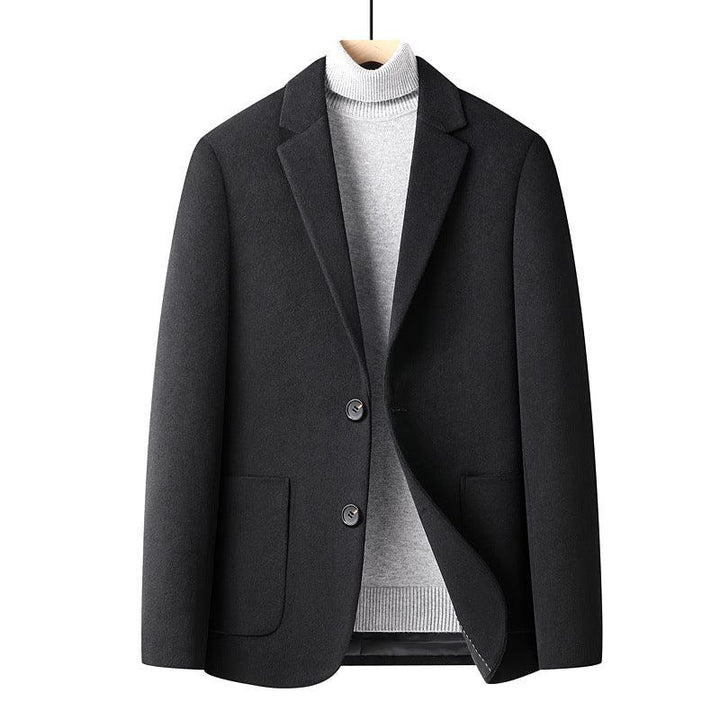 Black men's blazer jacket over light gray turtleneck sweater on wooden hanger