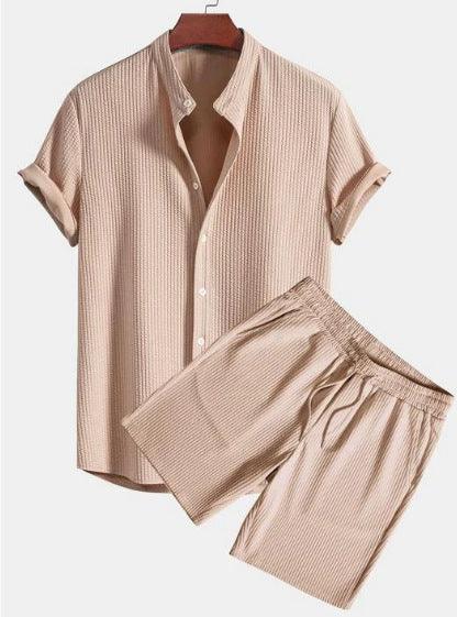 Beige textured short sleeve button-up shirt with rolled cuffs and matching elastic waist shorts set