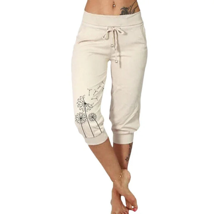 Women's beige capri sweatpants with drawstring waist and dandelion print on left leg