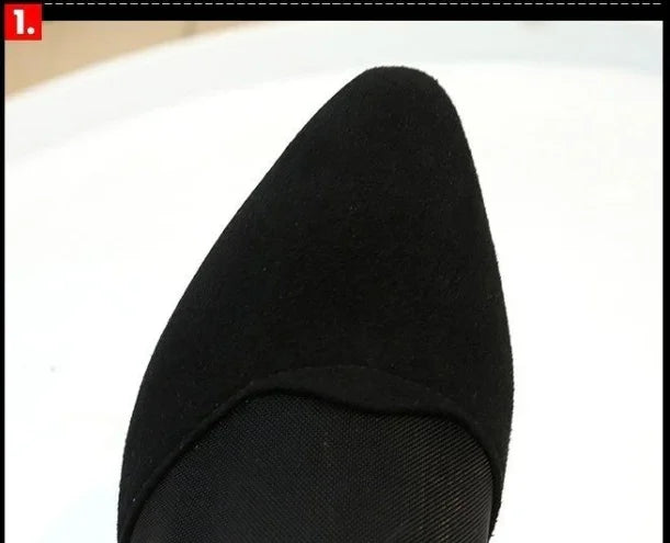 close-up of a black pointed-toe shoe upper with smooth fabric texture on white background