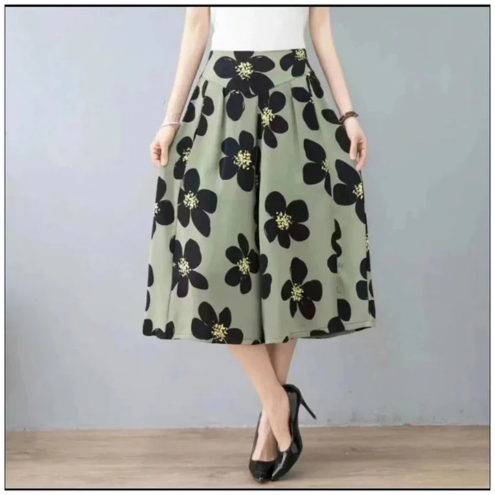 Woman wearing olive green skirt with large black floral print and black high heels