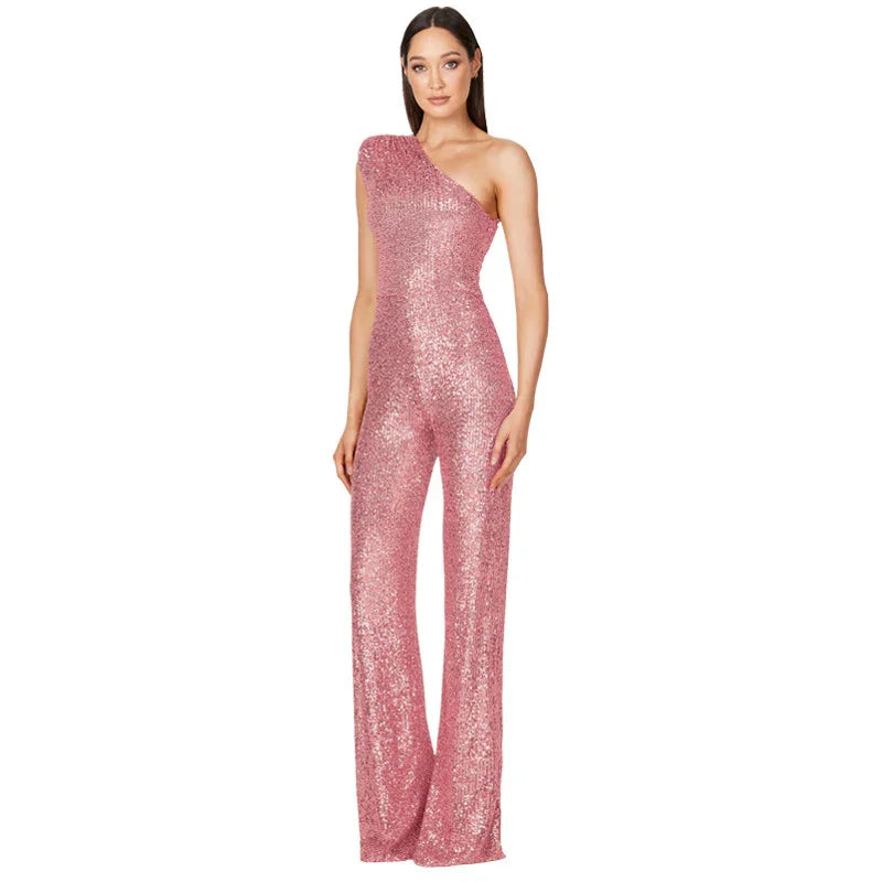 Woman wearing pink sequined one-shoulder jumpsuit with flared legs on white background