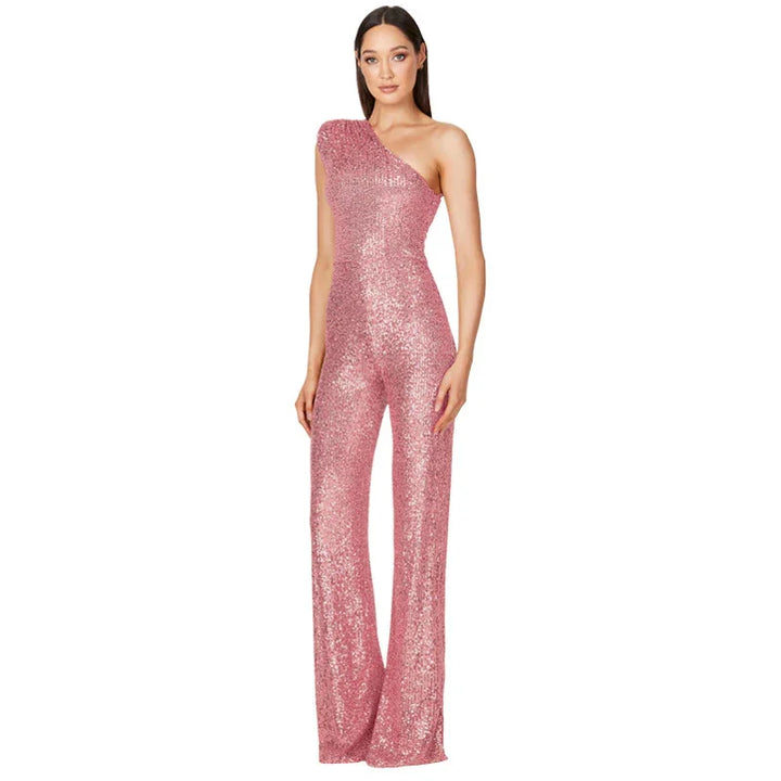 Woman wearing pink sequined one-shoulder jumpsuit with flared legs on white background