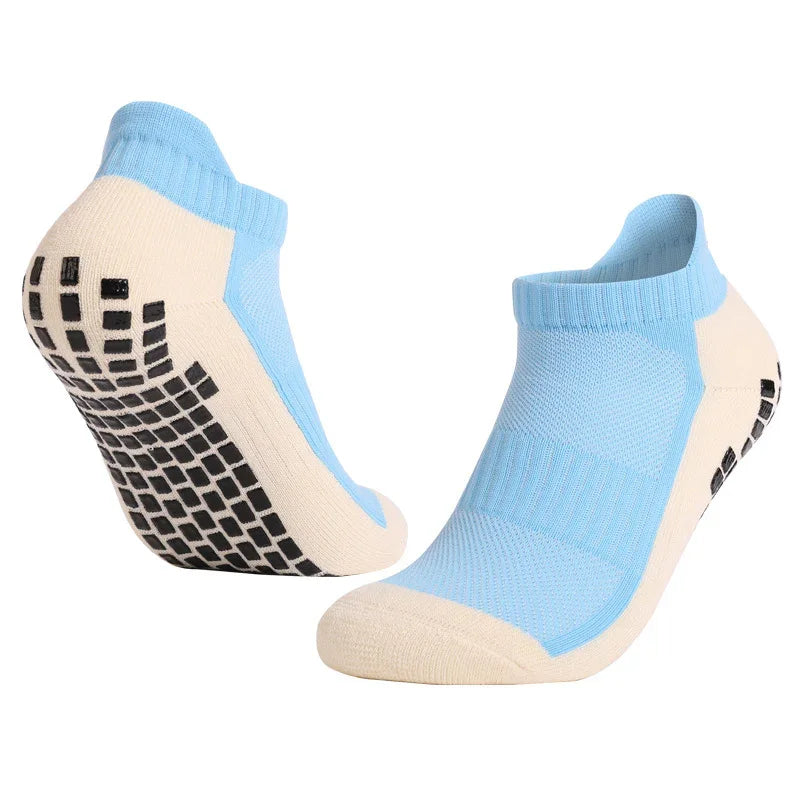 Blue and beige grip socks with non-slip black rubber soles, ankle length athletic design